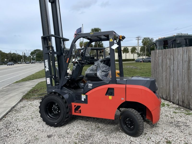 Rough terrain pneumatic tire forklift staged roadside before transport