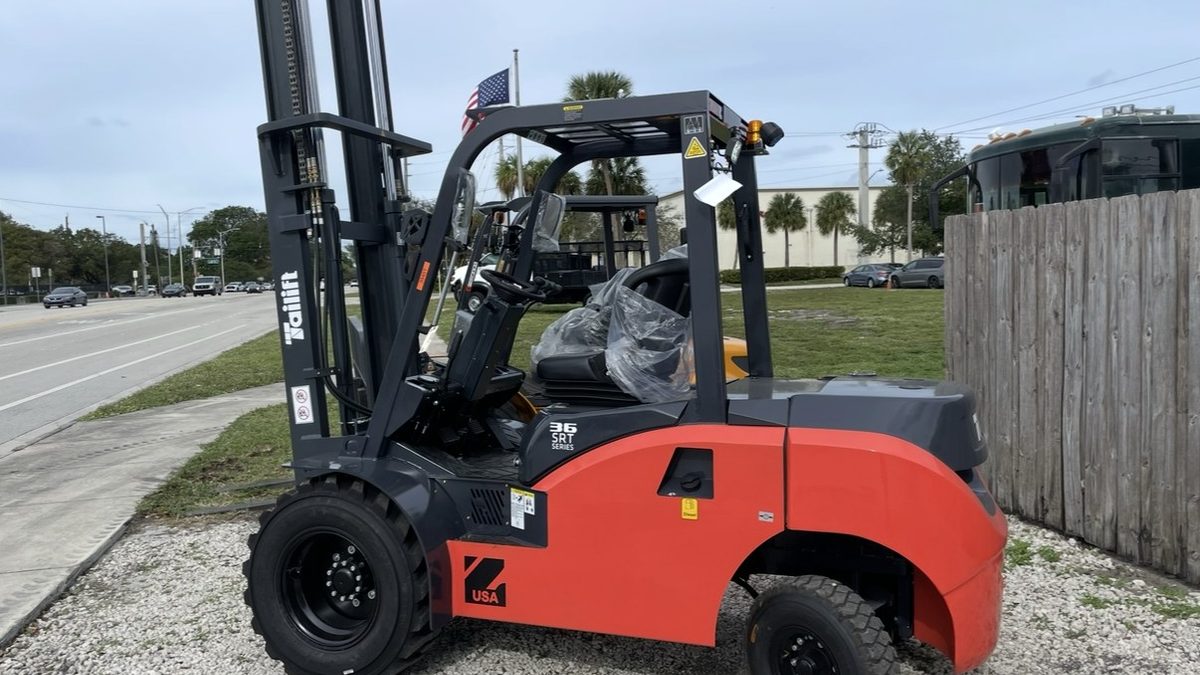 Rough terrain pneumatic tire forklift staged roadside before transport