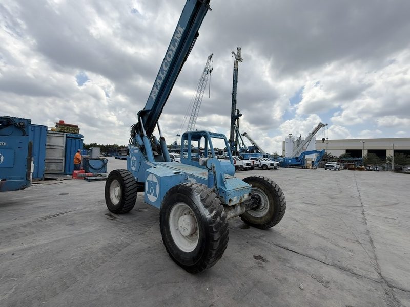 Telehandler telescopic boom forklift with boom extended at an industrial site