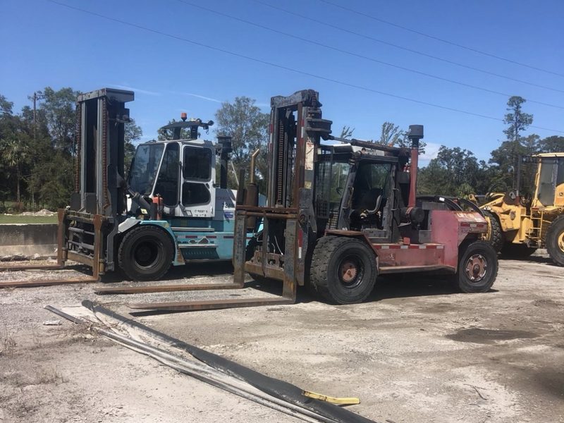 Large capacity forklifts parked together on a lot after a surplus forklift purchase