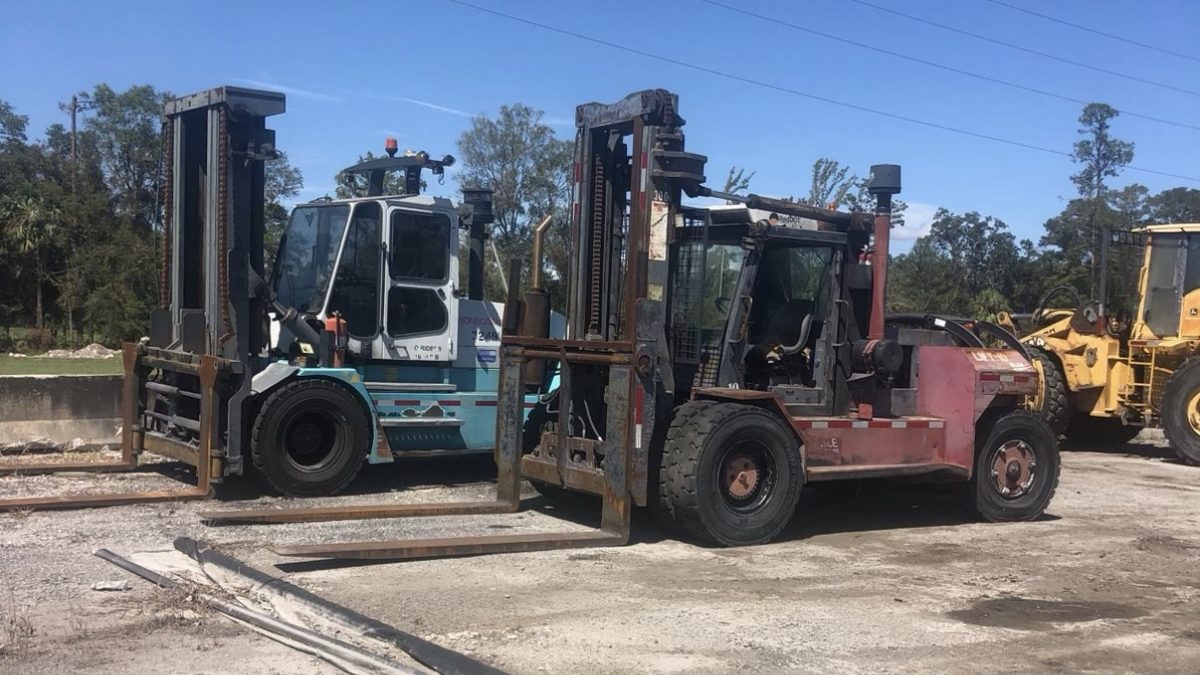 Large capacity forklifts parked together on a lot after a surplus forklift purchase