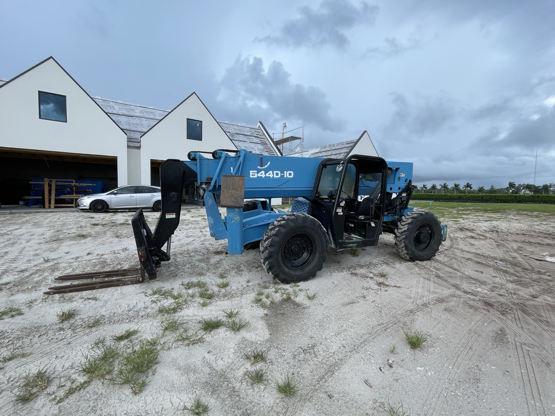 Blue telehandler at a building site